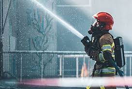 Firefighter in front of equipment